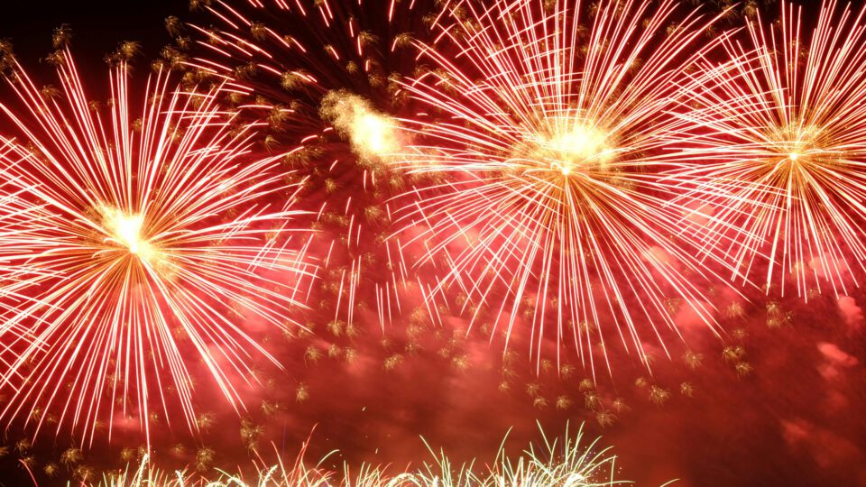 dazzling red fireworks burst at night sky