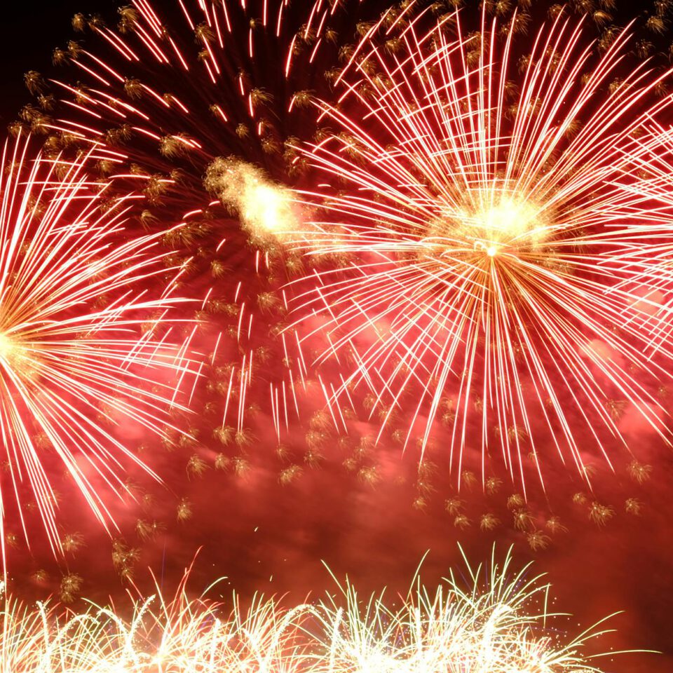 dazzling red fireworks burst at night sky